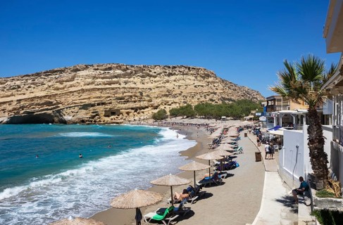Matala beach with a view of the rock caves, south coast, Crete, Greece