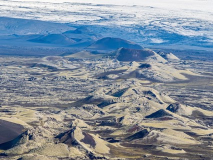 Moss-covered Laki crater or Lakagígar, series of craters, crater continue below glacier