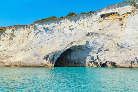 People swimming near sea cave, Kleftiko, Milos Island, Cyclades Islands, Greece