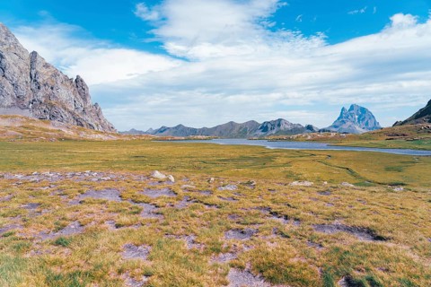 Scenic view of the lush, open landscapes at Ibones de Anayet in Huesca, Spain. The vibrant green
