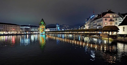 Wassertum with light installation, Chapel Bridge on the right, Jesuit Church on the Reuss at dusk