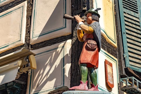 Wooden figure of a piper from 1300 in Ribeauville, Alsace, France