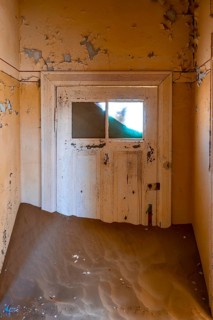 Interior view, door and house full of sand, former diamond mining town, Namib Desert, Kolmanskop,
