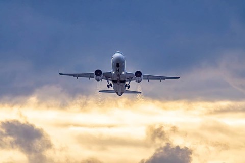 Stuttgart airport with plane taking off. Eurowings Airbus A320 in front of dark clouds, lighting in
