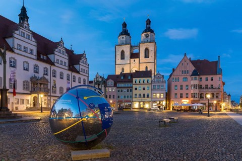 Atmospheric night view of market square with city church and old town hall, Luther city Wittenberg,