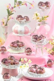 Punch balls, pink-coated chocolates on various glass plates with flower arrangements, pink
