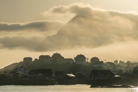 Village with houses in the fog, backlight, sea fog, A i Lofoten, Lofoten, Norway