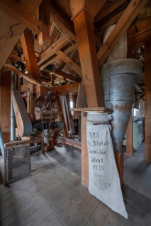 Historic plansifter in a former corn mill, old flour sack from 1936 on the right, Bavaria, Germany