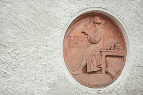 Monument and relief of Johannes Gutenberg printing, books, historic Grandpierre printing house, red