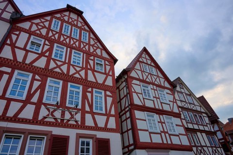 Three half-timbered houses with distinctive red wood and traditional construction, spa town of Bad