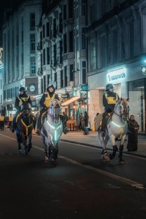 Three policemen on horses patrol Harley Street at night, New Year's Eve London, United Kingdom