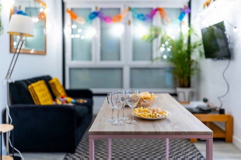 Empty living room with snacks and wine glasses ready for a party