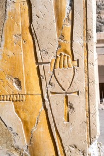Ankh, an ancient Egyptian symbol known as the Key of Life, in a hand of a Pharaoh god on the wall