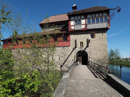 Medieval castle with stone walls and wooden drawbridge over a moat, Hagenwil moated castle,