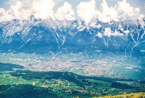 Elevated oblique view of the glaciated mountains of the Inn Valley rising above the city of