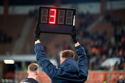 Sideline referee shows 4 minutes added time during the football match in Lubin, Poland