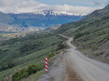 Road Carretera Austral north of Cochrane, gravel road in front of snowcovered mountains, Patagonia,