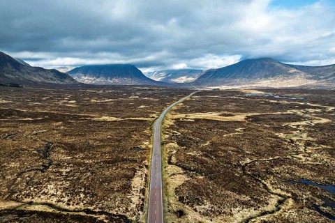 Moors and Road A82 over Glencoe Valley from a drone, Highland, Scotland, United Kingdom