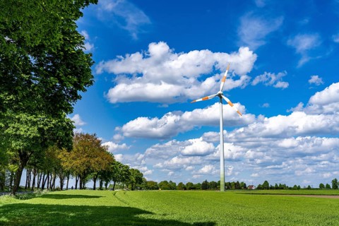 Wind turbine, wind energy plant from the manufacturer Enercon, blue sky with many white clouds,