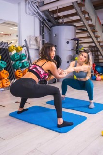 Lifestyle of friends training in a gym, sports and wellness in salur. Girls performing hand-held