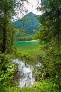 Breathtaking view of the emerald green waters of lake dobbiaco, nestled amidst the majestic
