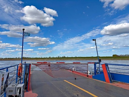 Bright scene with a ferry on a river under a cloudy blue sky, Lenzen, Gartow, Elbe, Lower Saxony,