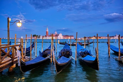 Romantic vacation Venice travel background, gondolas at Saint Mark (San Marco) square and Basilica