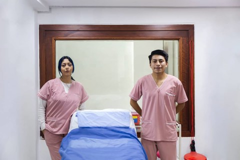 Two professional physiotherapists in a modern clinic in Ecuador, showcasing a welcoming treatment