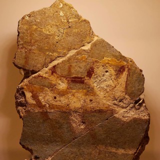 Early Mycenaean wall rock painting, prehistoric rock painting with rudimentary animal figures in