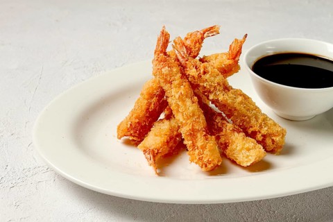 Fried shrimp, peeled in tempura, soy sauce, close-up