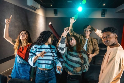 Friends dancing and having fun at a movie disco event, enjoying music and togetherness in a unique
