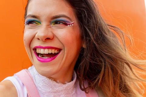 Celebrate diversity and artistry with this vibrant image of a woman radiating joy. Showcasing