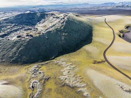 Mountain road F206 along moss-covered Laki crater or Lakagígar, series of craters, aerial view,