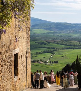 Tourists traveling in the small town of Pienza in Tuscany, Italy