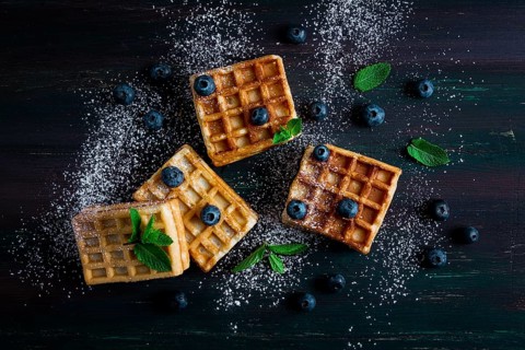 Viennese waffles with blueberries, on a dark background, breakfast, no people, selective focus