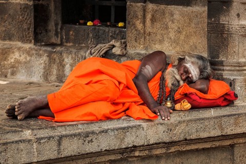 TIRUVANAMALLAI, INDIA, JANUARY 7, 2010: Sadhu, religious ascetic or holy person, sleeping in Hindu
