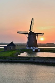 Historic windmill in the light of the setting sun, De Traanroeier, Het Noorden Molen, Texel, North