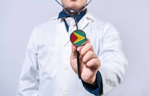 Doctor hands holding stethoscope with Guyana flag. Guyana health and care concept