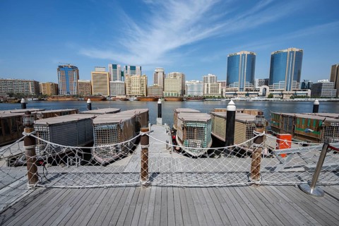 View of traditional boats and skyscrapers from Old Town Dubai, Dubai, United Arab Emirates