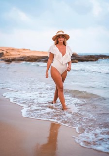 Lifestyle of a blonde Caucasian girl in a white swimsuit enjoying the summer. Strolling on the