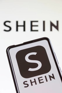 Shein logo online marketplace online trading ecommerce on a mobile phone and computer screen