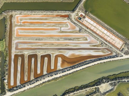 Saline ponds at the salt works near Chiclana de la Frontera. The orange-red colour depends on the