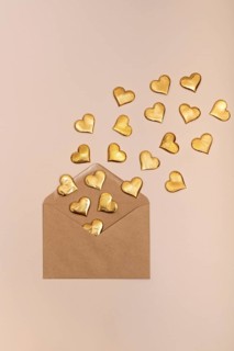 Golden heart shapes emerging from a craft envelope, symbolizing love and celebration, ideal for St.
