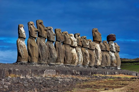 Row of Moai Statues on Easter Island against a clear blue sky, The Moai Statues on Easter Island in