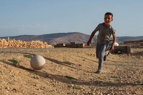 Taouloukoult, MOROCCO - OCTOBER 6, 2024: young boys spend the afternoon playing amateur football on