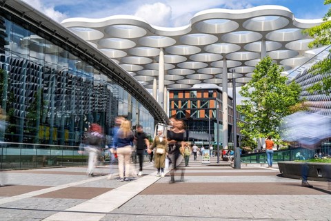Station forecourt of Utrecht Centraal station, people on their way to, from the station,