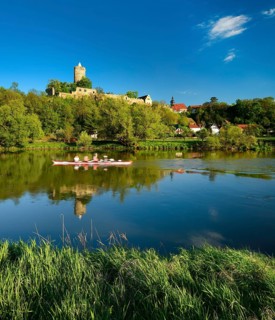 Rowing boat on the river Saale in the Saale valley near Naumburg, the ruins of Schönburg Castle are