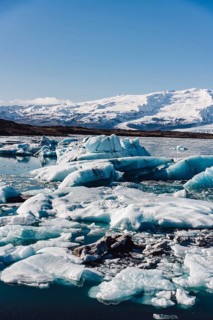 A stunning scene of icebergs floating in the calm waters of the Jokulsarlon glacier in Iceland.
