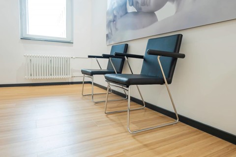 Two modern chairs next to a window with wall art in the background, radiology in the new health