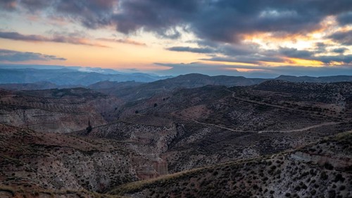 Sunrise, wide hilly desert landscape with dry vegetation, Gorafe desert, semi-desert, Granada,